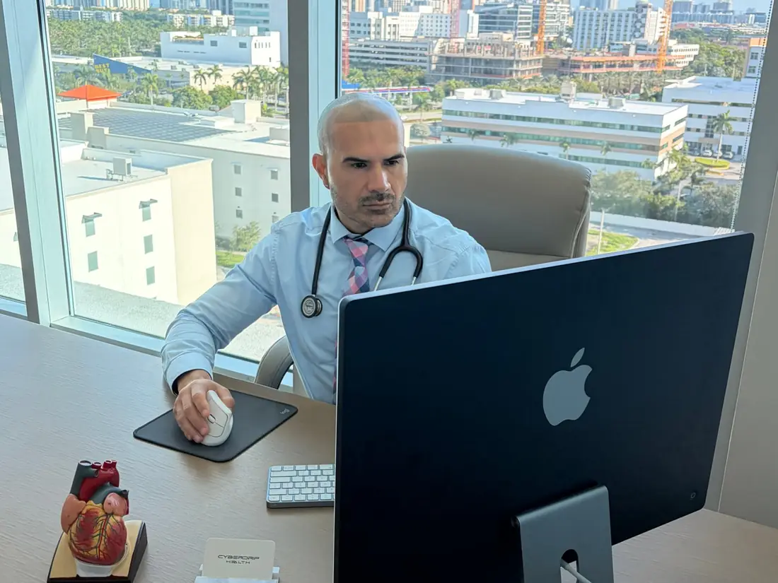 A Cyberdrip Health provider working at his desk in the Aventura office